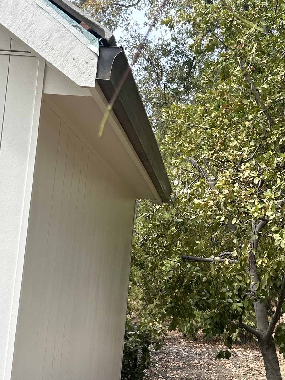 Dark gutter and downspout closeup on Sacramento home