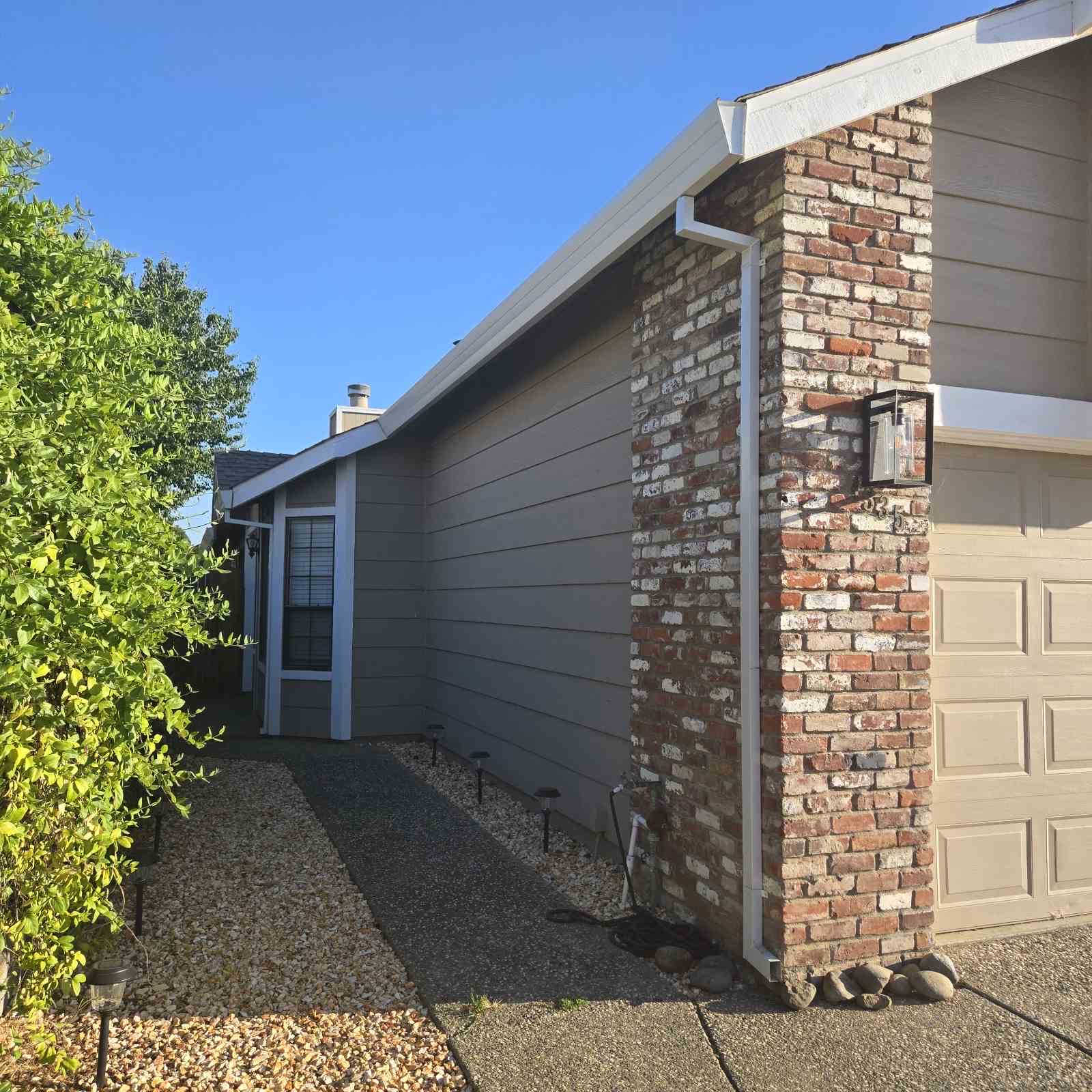 Front view of gutters and downspout on brick Sacramento home