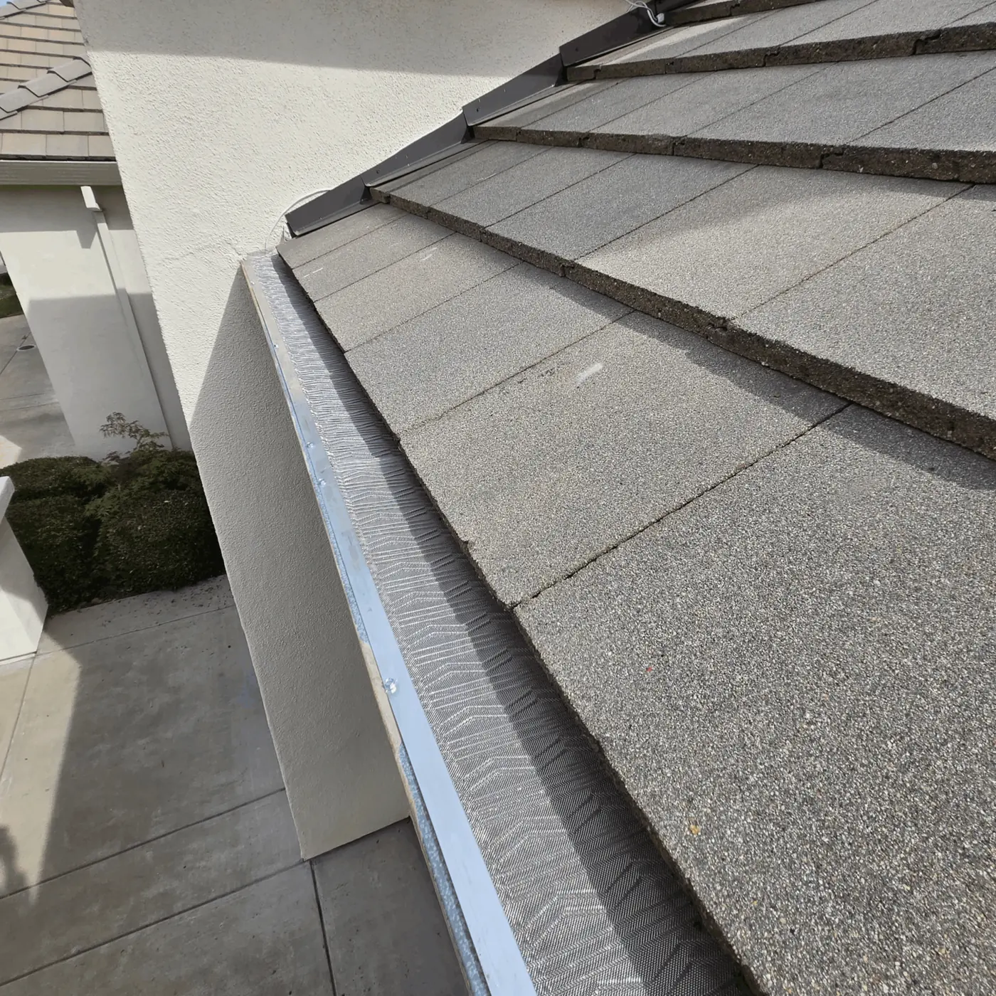 Micro-mesh guard on a white seamless gutter along the fascia