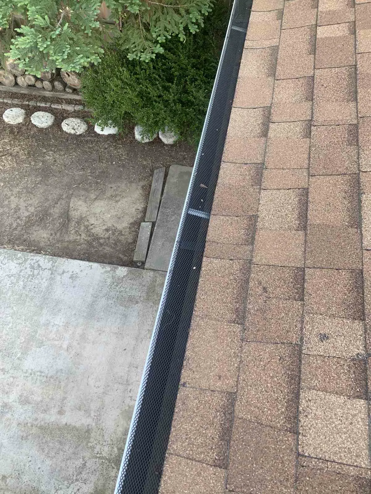Roof-level view of micro-mesh gutter guard installation