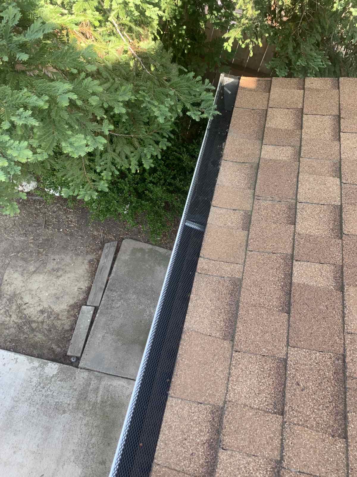 Mesh gutter guard along roofline viewed from above in Sacramento