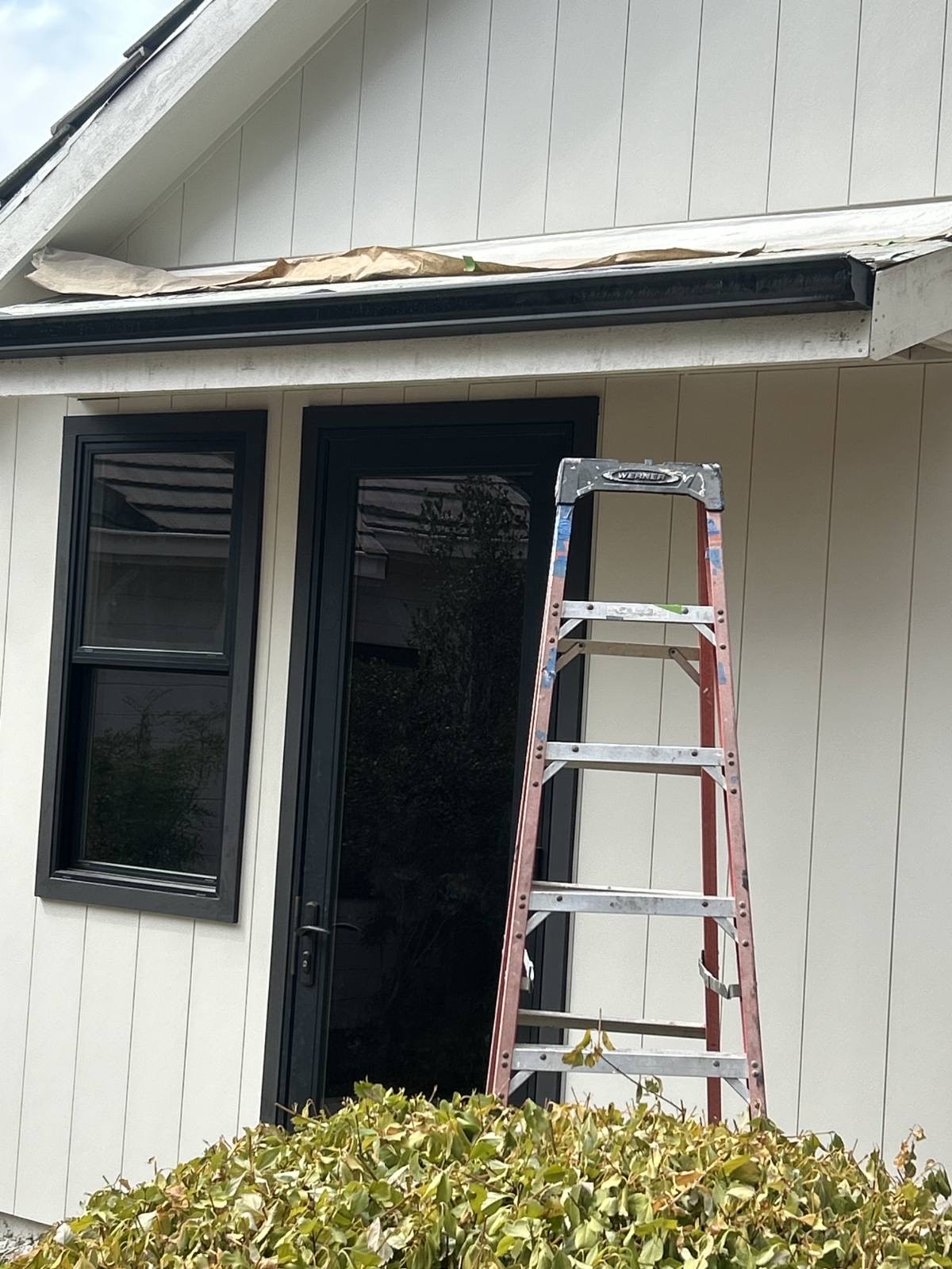 Gutter installation in progress with ladder at Sacramento home entry