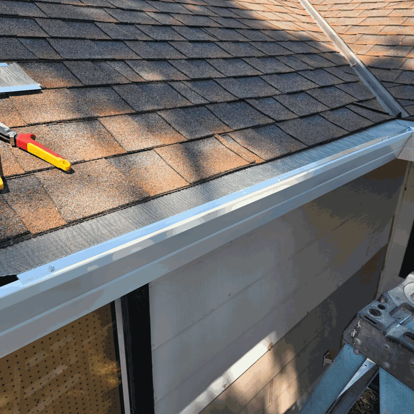 Micro-mesh gutter guard being installed along a Sacramento roofline