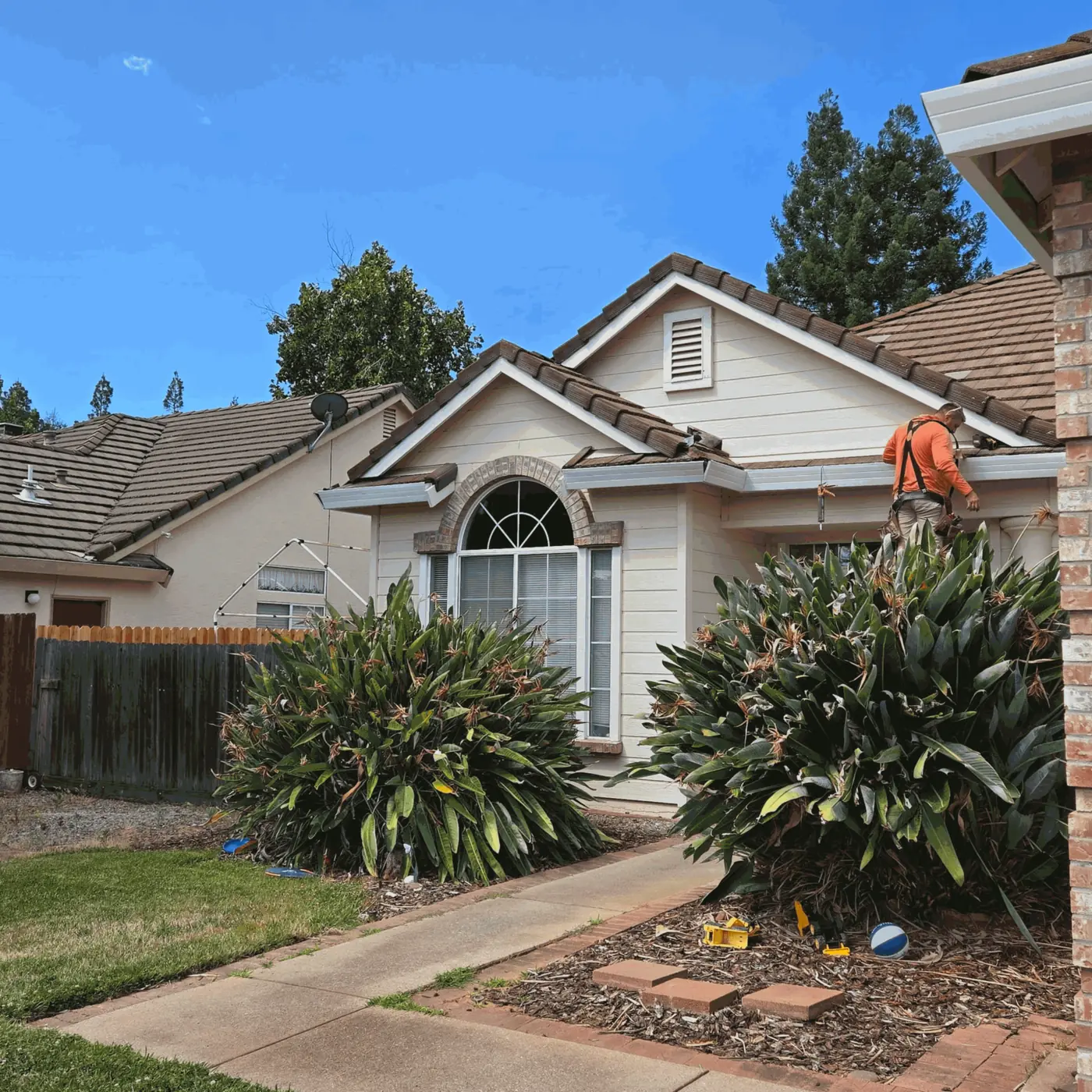 Gutter installation in progress at the entry of a Sacramento-area home