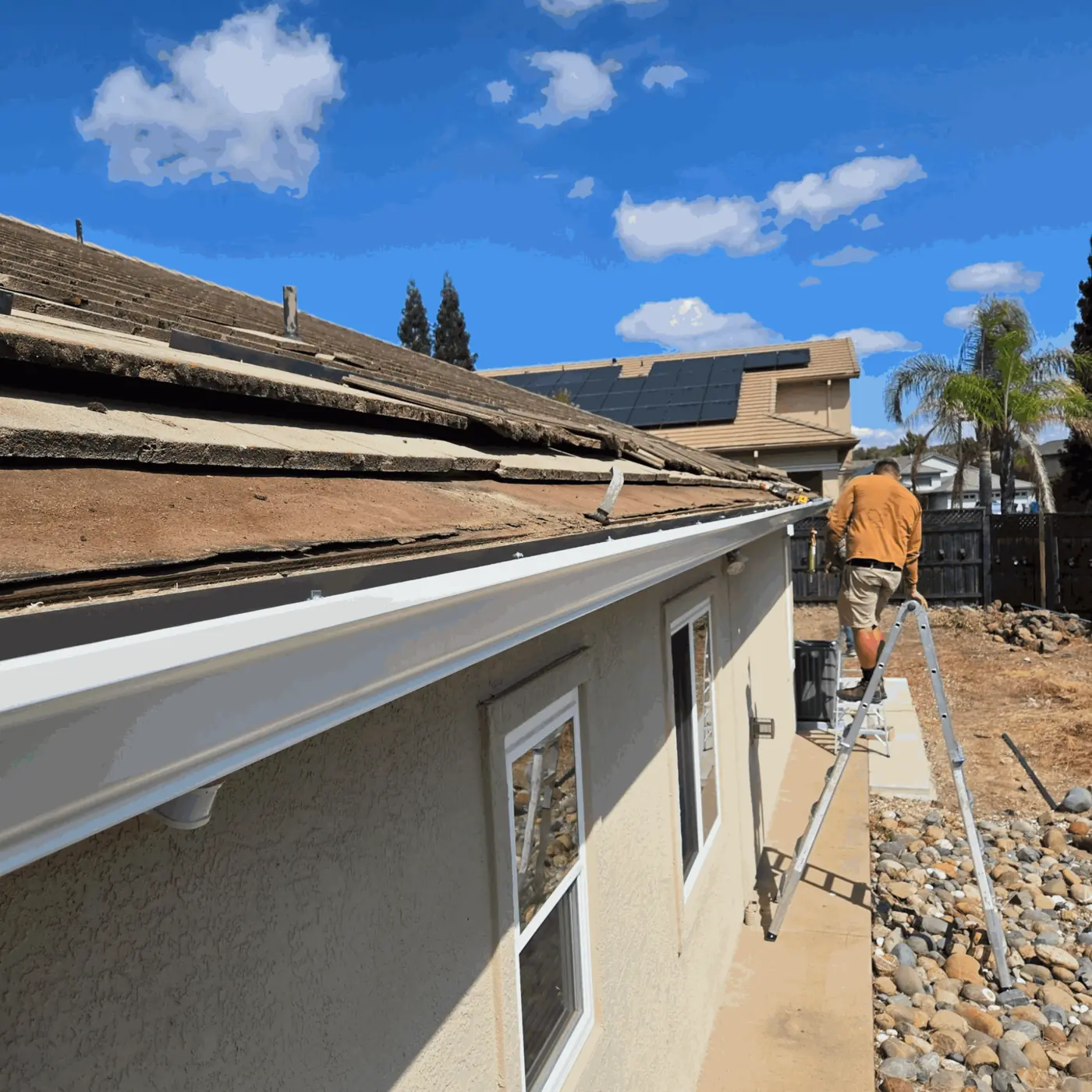 New seamless gutter run along the eave of a Sacramento-area stucco home