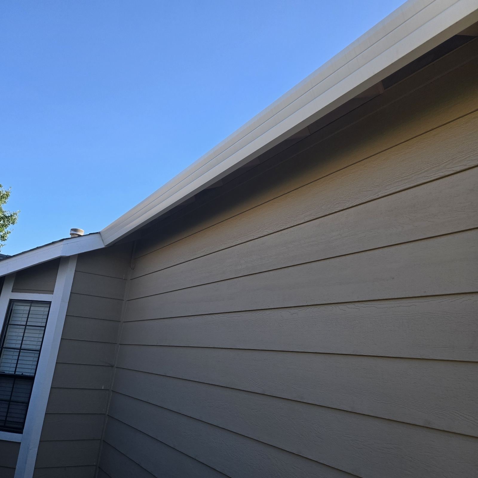 Seamless gutter along siding closeup on Sacramento home