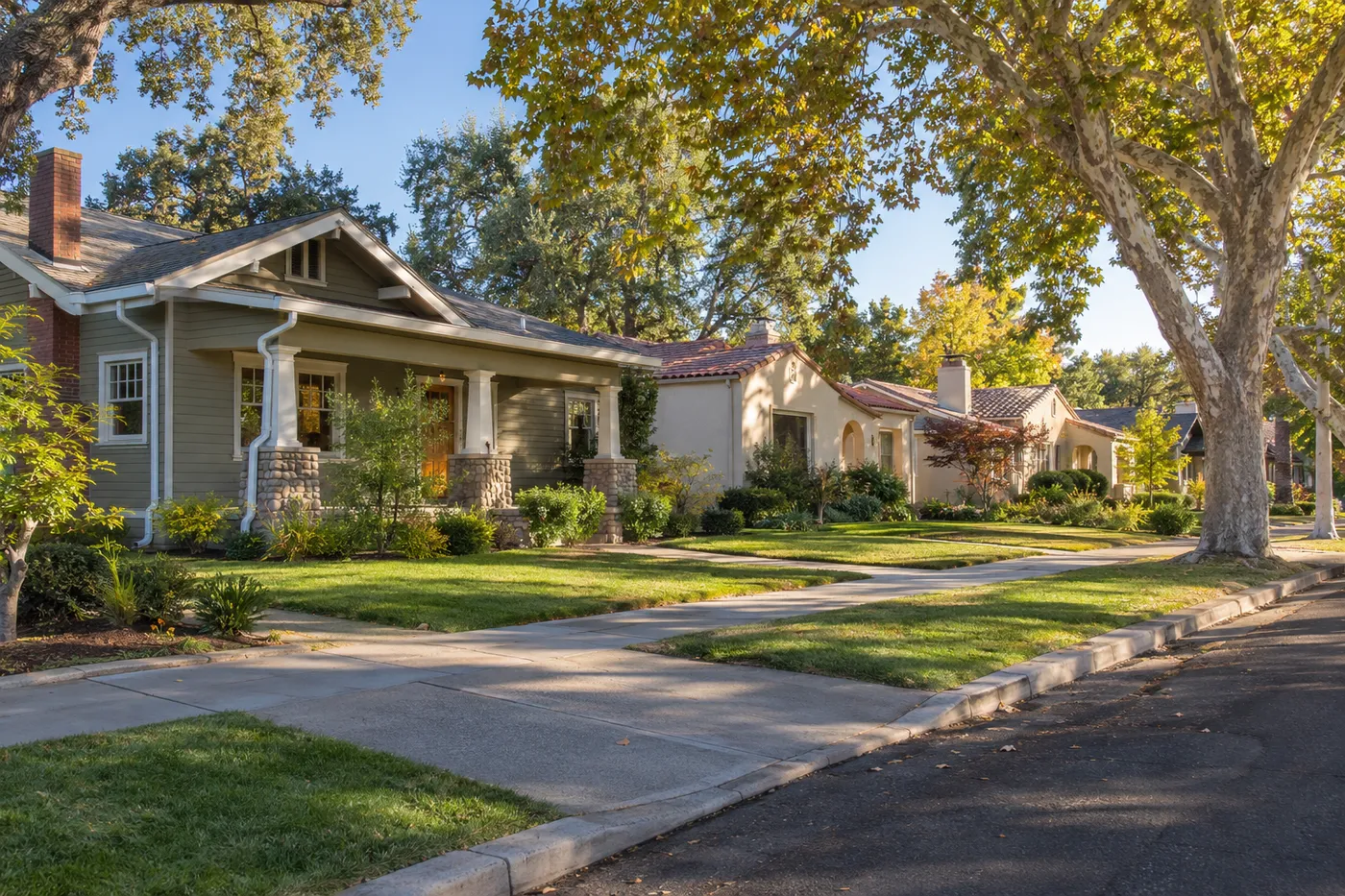 Tree-lined Sacramento-area street with a Craftsman bungalow and stucco homes